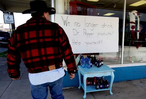Sign in store window says "We no longer drink Dr. Pepper products: help yourself!